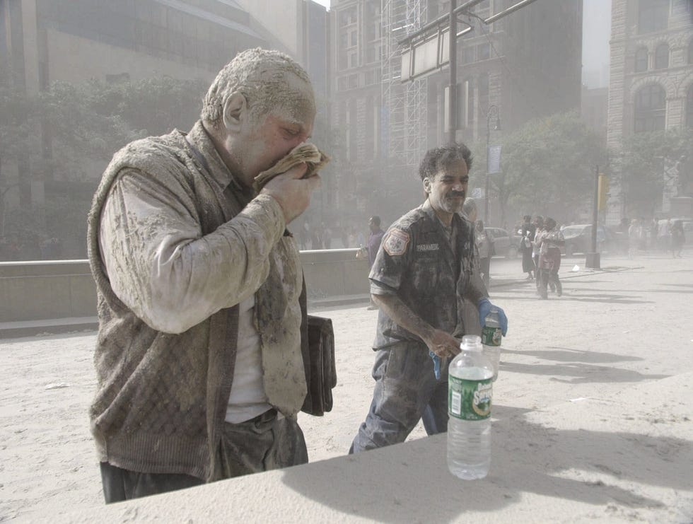 A man coated with ash and debris from the collapse of the World Trade Center south tower coughs near City Hall in lower Manhattan Sept. 11, 2001.