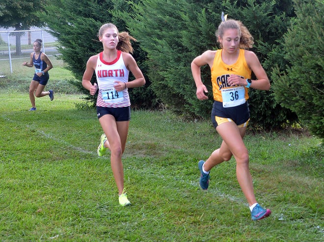 North Hagerstown's Lauren Stine trails Frederick's Caroline Gregory early in the Rebel Invitational girls race at South Hagerstown on Sept. 10, 2022. Gregory won the race in 19:03.6. Stine finished second in 19:34.1, leading the Hubs to a third-place team finish.