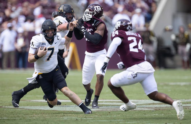 Sep 10, 2022; College Station, Texas, USA; Appalachian State Mountaineers quarterback Chase Brice (7) rushes against Texas A&M Aggies linebacker Chris Russell Jr. (24) in the second quarter  at Kyle Field. Mandatory Credit: Thomas Shea-USA TODAY Sports