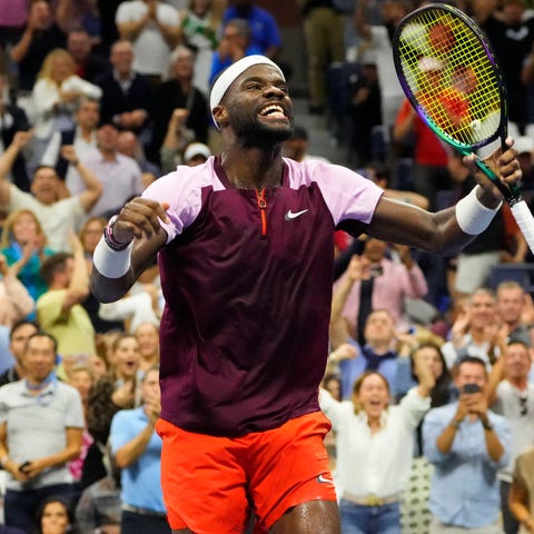 Frances Tiafoe celebrates after winning a fourth s