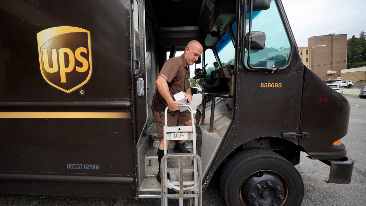 UPS driver Joe Speeler makes a delivery at the Leanon Shops in Mount Lebanon, Pa., on Tuesday, Sept. 21, 2021. United Parcel Service said Wednesday, Sept 7, 2022, it plans to hire more than 100,000 extra workers to help handle an increase in packages during the critical holiday season. Thatâ€™s similar to the holiday seasons of 2021 and 2020.  (AP Photo/Gene J. Puskar)