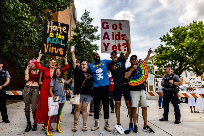 Counter protestors shout "love always wins" in front of the pride protesters in an attempt to drown out their message on Saturday.