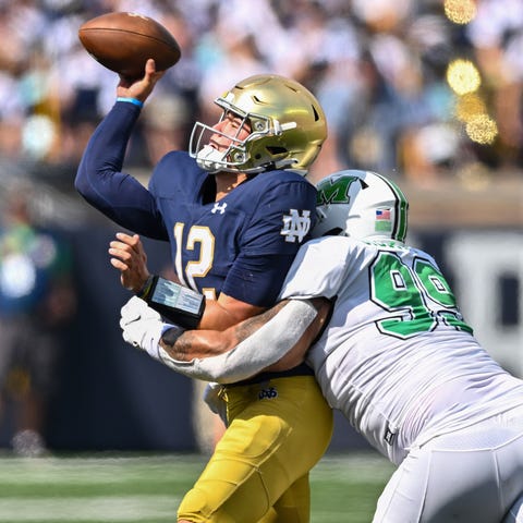 Notre Dame quarterback Tyler Buchner (12) throws a
