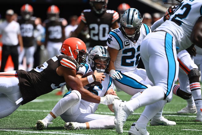Carolina Panthers quarterback Baker Mayfield (6) is sacked by Cleveland Browns defensive end Myles Garrett (95) after a bad snap.