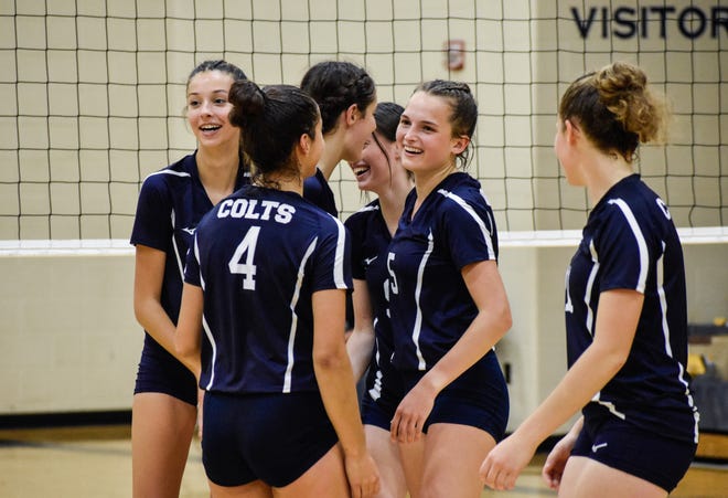Academy Volleyball celebrates during their tri-match victory over the weekend.
