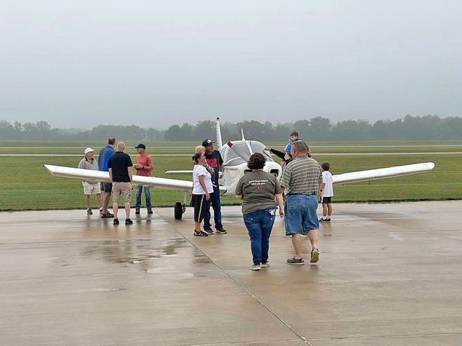 Festival-goers check out a Cessna brought in to Hillsdale's Fly In Sunday at Hillsdale Municipal Airport.