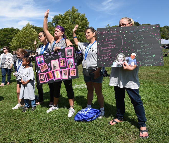 Emily Marie (left), with her daughter Jaesey, 8, and friend, Angel Ford, 6, along with Kimberly Finch, who lost her daughter Krystayna Finch, stands with Cherri Walker and Teresa Mossing holding a sign in remembrance of Cryskal Black and Larry Mullins at the Recovery Advocacy Warriors (RAW) annual picnic Saturday.
(Photo: Tom Hawley, The Monroe News)