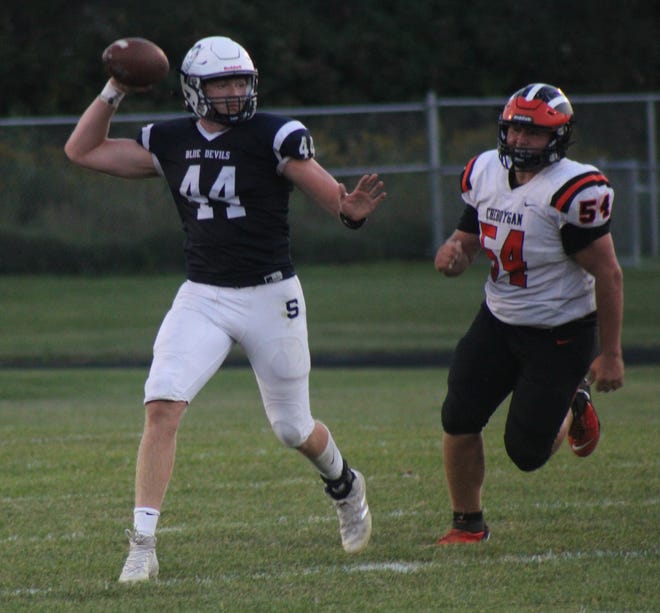 Sault Ste. Marie quarterback Callen Campbell rolls out on pass while being chased by a Cheboygan defensive lineman Friday.