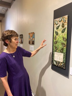Margaret Lincoln discusses a mosaic on display at the Art Center of Battle Creek on Friday, Sept. 9, 2022 in Battle Creek. The artwork is part of a traveling exhibit made in reaction to the 2018 terrorist attack on Tree of Life Synagogue in Pittsburgh.