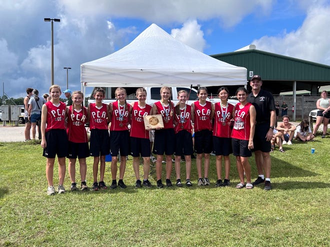 The Pensacola Christian girls cross country team pose for photos after taking first place at the Gulf Coast Stampede on Saturday, Sept. 11, from the Escambia Equestrian Center.