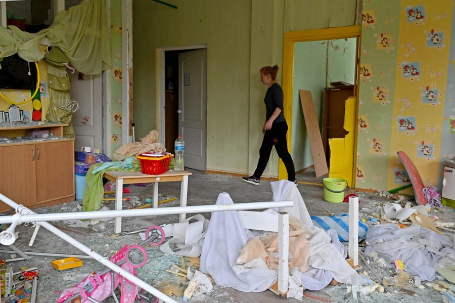 An employee walks throught debris and broken glass in a kindergarten partially destroyed as a result of a missile strike, in Kharkiv, on September 11, 2022, amid the Russian invasion of Ukraine.