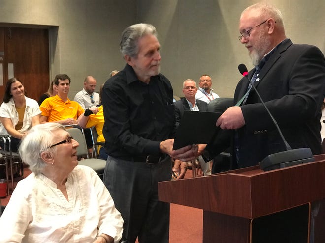 Former Anderson County Commissioner Jerry Creasey, center, receives a proclamation and key to the city from Oak Ridge Council member Chuck Hope, right. Creasey, joined by his wife, Tanyia, left, represented one of three Oak Ridge districts on the County Commission for 32 years.