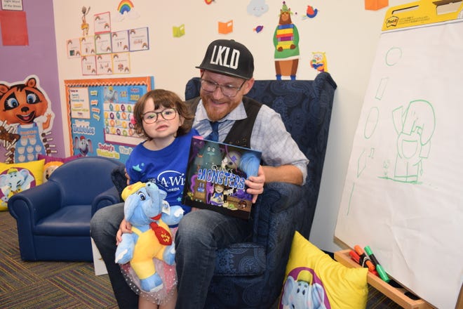 Quinn McBride with author Fred Koehler, who spearheaded the writing of "Quinn's Monsters" as part of fulfilling the girl's Make-A-Wish request.