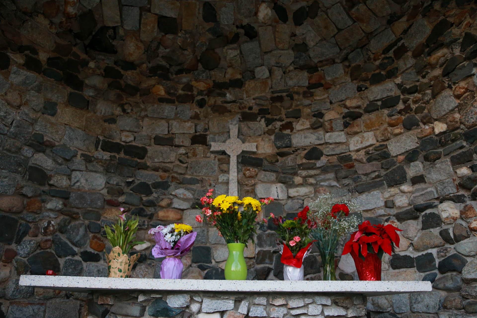 Flowers adorne the alter inside the grotto at Our Lady of Lourdes Catholic Church in Port Wentworth.