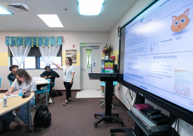 English teacher Tracy Fischetti, center, conducts a Teacher Academy class at Navarre High School on Tuesday.