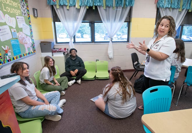 English teacher Tracy Fischetti, right, sets up a simulated kindergarten teaching scenario during a Teacher Academy class at Navarre High School on Tuesday.