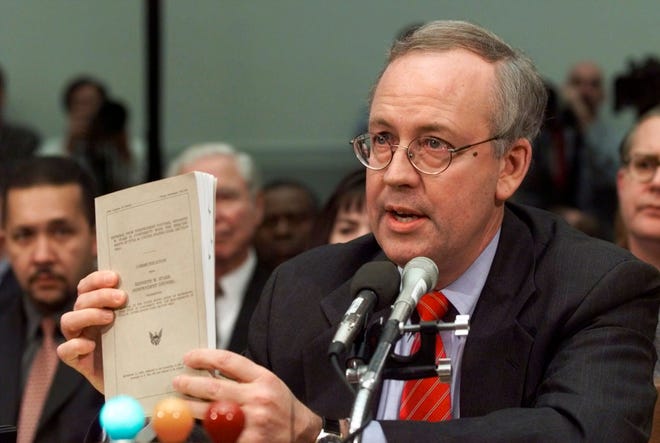 FILE - Independent Counsel Kenneth Starr holds a copy of his report while testifying on Capitol Hill Thursday Nov. 19, 1998, before the House Judiciary Committee's impeachment hearing. Starr, whose criminal investigation of Bill Clinton led to the president’s impeachment, died Sept. 13, 2022. He was 76. (AP Photo/Doug Mills, File) ORG XMIT: WX122