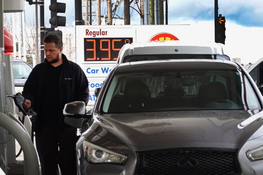 A person purchases gas at a Shell station on September 12, 2022 in Bensenville, Illinois. According to a survey from the New York Federal Reserve, falling gas prices are raising optimism that inflation is on the decline.