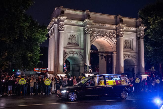 The Royal Hearse carrying the coffin of Queen Elizabeth II drives past Wellington Arch on Sept. 13, 2022 in London, on the way to Buckingham Palace after a RAF flight from Scotland, where she died on Sept. 8. The coffin will rest in the Bow Room of the palace until the lying-in-state at Westminster Hall begins Sept. 14.