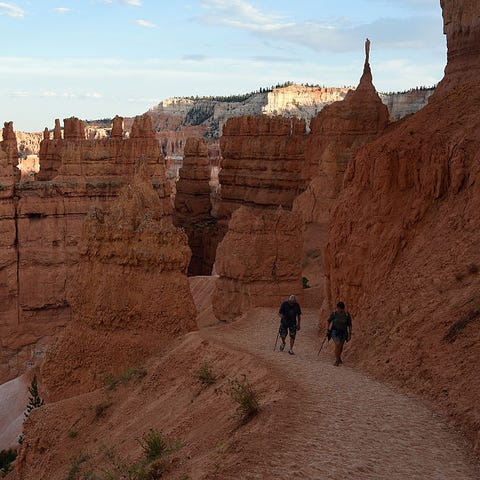 Visitors walk along the Navajo Loop Trail at Bryce