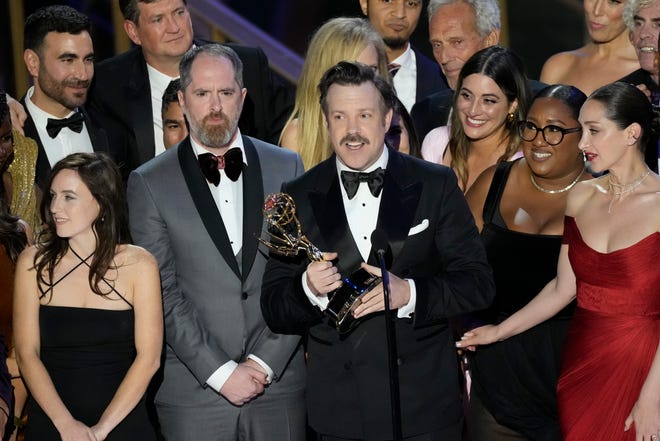 Jason Sudeikis (c) and the cast and crew of the Apple TV+ program “Ted Lasso” accept the award for award for outstanding comedy series.