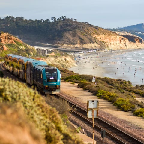 A train travels along beachfront tracks by Torrey 