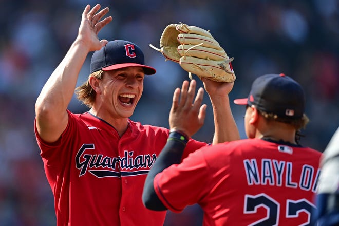 Cleveland Guardians relief pitcher James Karinchak, right, and Josh Naylor celebrate after a ground out by Los Angeles Angels' Mike Ford during the ninth inning of a baseball game, Wednesday, Sept. 14, 2022, in Cleveland. The Guardians won 5-4. (AP Photo/David Dermer)