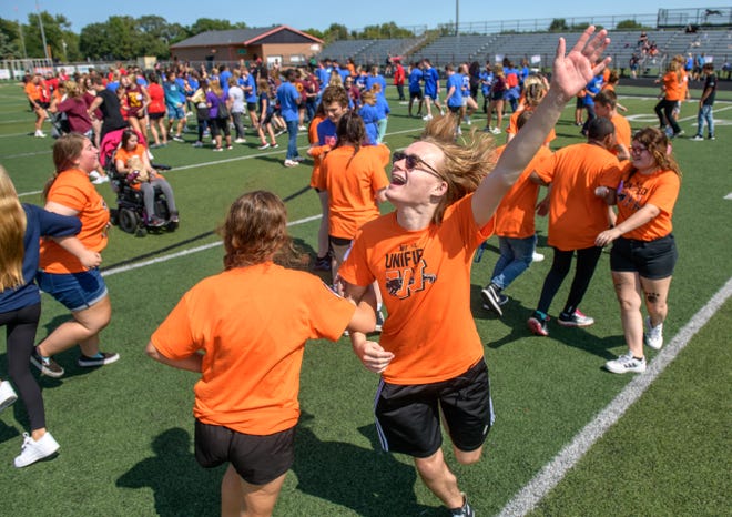 Charlie Smith, a junior at Washington Community High School, dances his heart out during a dance party on Babcook Field to end the Mid-Illini Unified PE Field Day on Wednesday, Sept. 14, 2022 in Washington. About 200 special needs students and their aides from across the Mid-Illini Conference played games, ran a balloon relay race and danced on the field for the inaugural event.