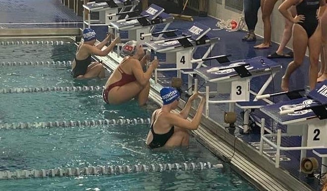 Emma O’Connell and Sara Carter of Dundee line up for the backstroke with Bedford’s Madison Walker Tuesday. O’Connell won the event to lead Dundee to a 122-59 victory.