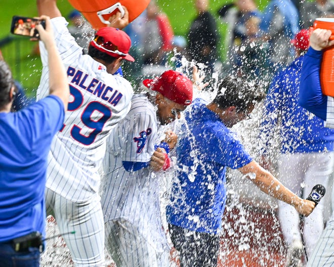 South Bend Cubs’ Daniel Palencia (29) pours water on Fabian Pertuz (8) after the South Bend Cubs defeated the Cedar Rapids Kernels 2-1 Tuesday, Sept. 13, 2022, at Four Winds Field. On Wednesday, Sept. 21, the Cubs defeated Lake County to win the best-of-three Midwest League Championship series. 
(Photo: MATT CASHORE, South Bend Tribune)