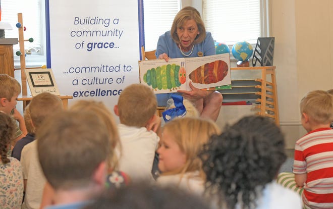 Ohio First Lady Fran DeWine reads from the book "The Very Hungry Caterpillar" on Wednesday afternoon to preschool and first grade students from St. Peter's Montessori School.