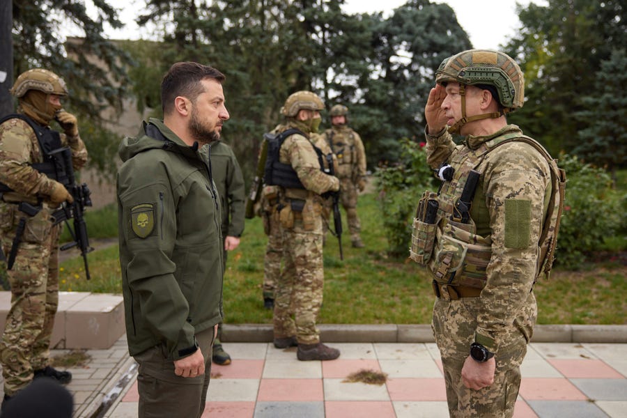 In this photo provided by the Ukrainian Presidential Press Office, Ukrainian President Volodymyr Zelenskyy, left, listens to Gen. Oleksandr Syrskyi's report during his visit in Izium, Kharkiv region, Ukraine, Wednesday, Sept. 14, 2022.