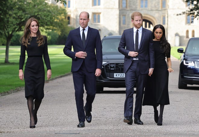 Princess Kate, Princess of Wales, Prince William, Prince of Wales, Prince Harry, Duke of Sussex, and Meghan, Duchess of Sussex on the long Walk at Windsor Castle, arriving to view flowers and tributes to Queen Elizabeth II on Sept. 10, 2022.