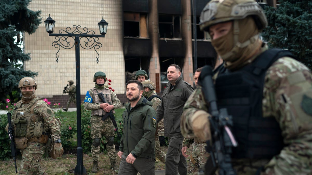 Ukrainian President Volodymyr Zelenskyy leaves after attending a national flag-raising ceremony in the freed Izium, Ukraine, Wednesday, Sept. 14, 2022. Zelenskyy visited the recently liberated city on Wednesday, greeting soldiers and thanking them for their efforts in retaking the area, as the Ukrainian flag was raised in front of the burned-out city hall building.