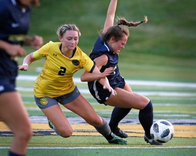 Adrian College's Mckenna Mahoney gets tangled up with Michigan Dearborn's Gabriella Teems during Wednesday's match at Docking Stadium.