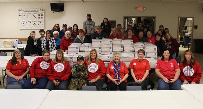 Military Families of Monroe County volunteers pose with care packages they assembled for Monroe County area servicemen and servicewomen.