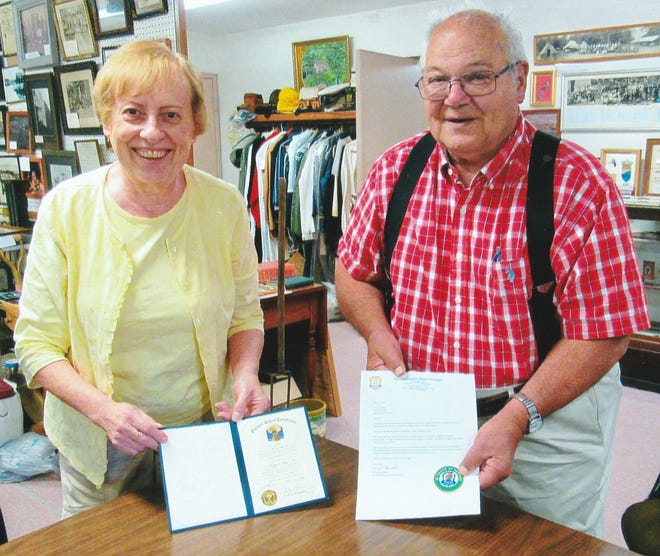 Virginia Hay displays her “Golden Sheaf Certificate” in recognition of her 50 consecutive years of membership at Hillcrest Grange while F. Carl Walker displays his 60 year seal for the Golden Sheaf certificate he received in 2012.
