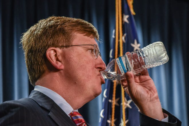Gov. Tate Reeves drinks bottled water during a press conference announcing that Jackson's boil water notice has been officially lifted in Jackson, Miss., Thursday, September 15, 2022. The city of Jackson's boil water notice has been in place since the end of July, and Gov. Reeves stated that he would be comfortable drinking the tap water from the Governor's mansion in Jackson.