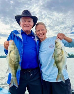 Dr. Vansickle and his daughter Erin hold up a pair of nice hybrid striped bass. Caught over 20 while fishing with Capt. Paul Tyre on Lake Seminole this past week.