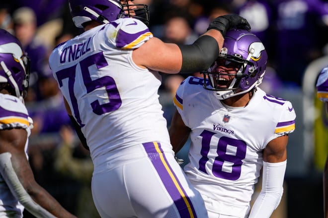 Minnesota Vikings wide receiver Justin Jefferson (18) celebrates his touchdown with offensive tackle Brian O'Neill (75) during the first half of an NFL football game against the Baltimore Ravens, Sunday, Nov. 7, 2021, in Baltimore.