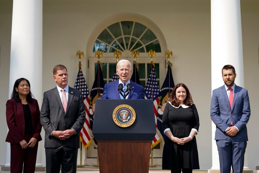 President Joe Biden speaks about a tentative railway labor agreement in the Rose Garden of the White House on Sept. 15, 2022, in Washington. From left, Deputy Secretary of Labor Julie Su, Secretary of Labor Marty Walsh, Biden, Celeste Drake, Made in America Director at the Office of Management and Budget, and National Economic Council director Brian Deese.