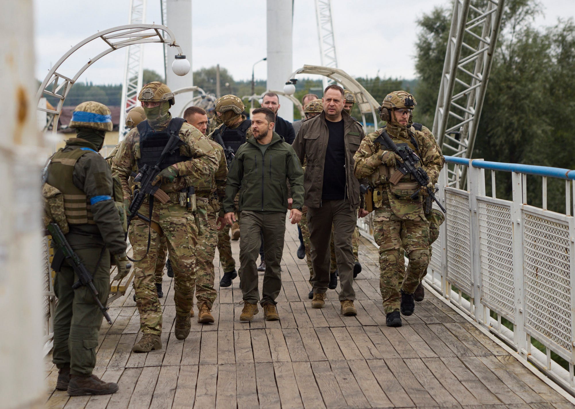 Ukrainian President Volodymyr Zelenskyy, center, is surrounded by soldiers during his visit to Izium, Kharkiv region, Ukraine, on Wednesday, Sept. 14, 2022. Ukrainian troops piled pressure on retreating Russian forces Tuesday, pressing deeper into occupied territory and sending more Kremlin troops fleeing ahead of the counteroffensive that has inflicted a stunning blow on Moscow's military prestige.