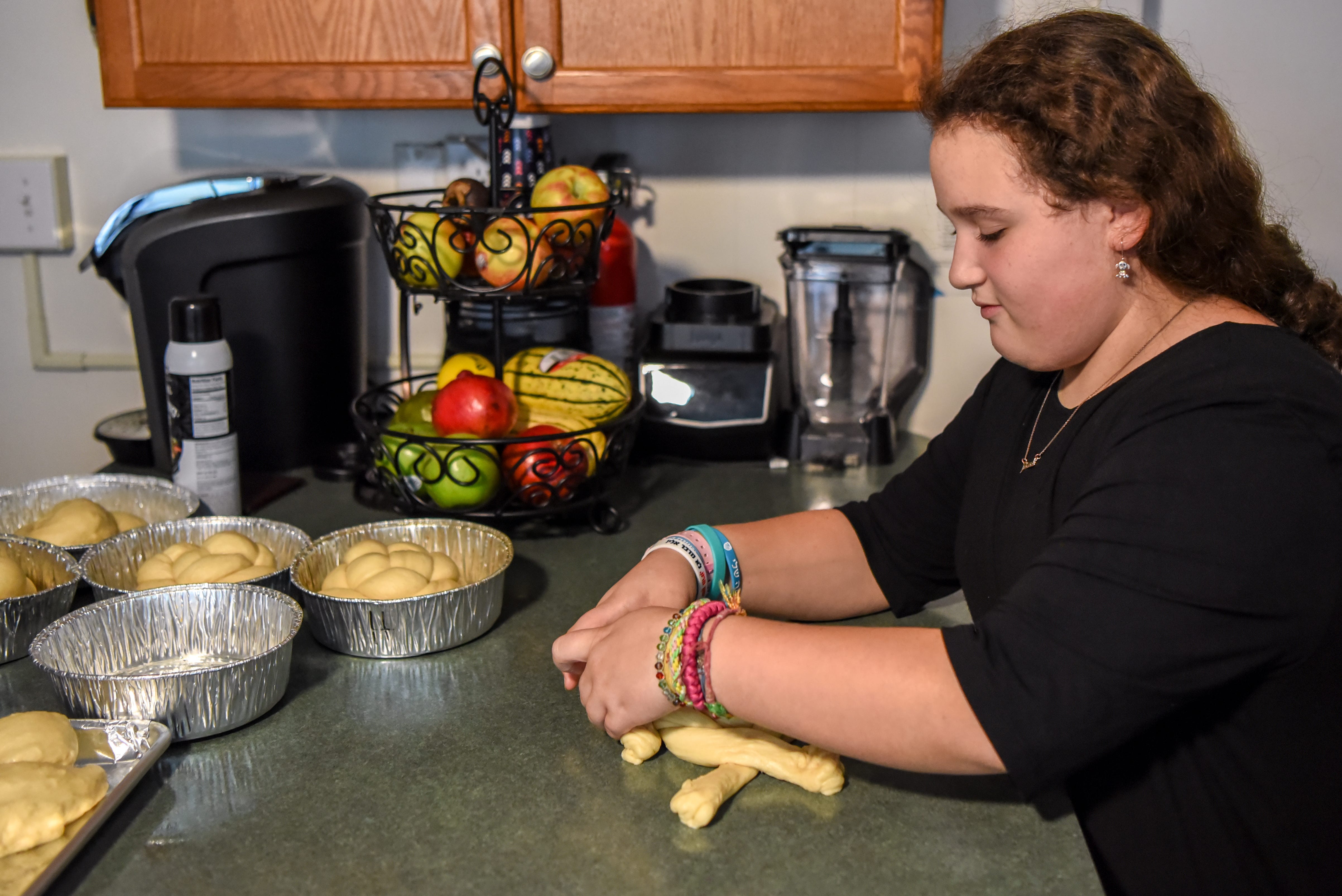 When is Rosh Hashana 2022? What is it? Can you say happy holidays? 14 Batya Weisinger, 11 makes round challah bread for Rosh Hashanah in her Teaneck, N.J., home on Sept. 27, 2019.