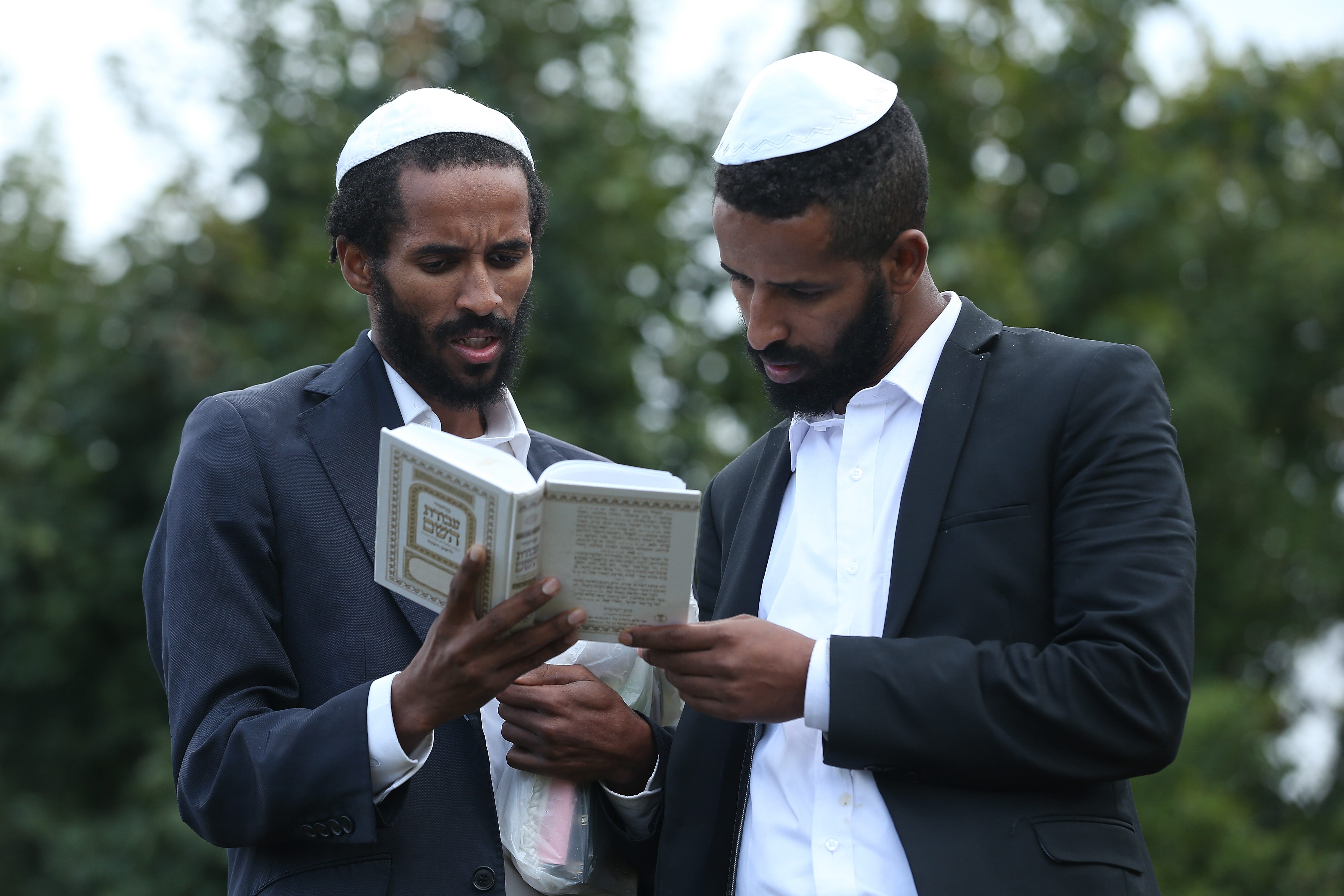 When is Rosh Hashana 2022? What is it? Can you say happy holidays? 9 Two Ethiopian Jews perform Tashlich, a Jewish atonement ritual, at a lake formed by the Umanka River on the first day of Rosh Hashanah on Sept. 10, 2018, in Uman, Ukraine.