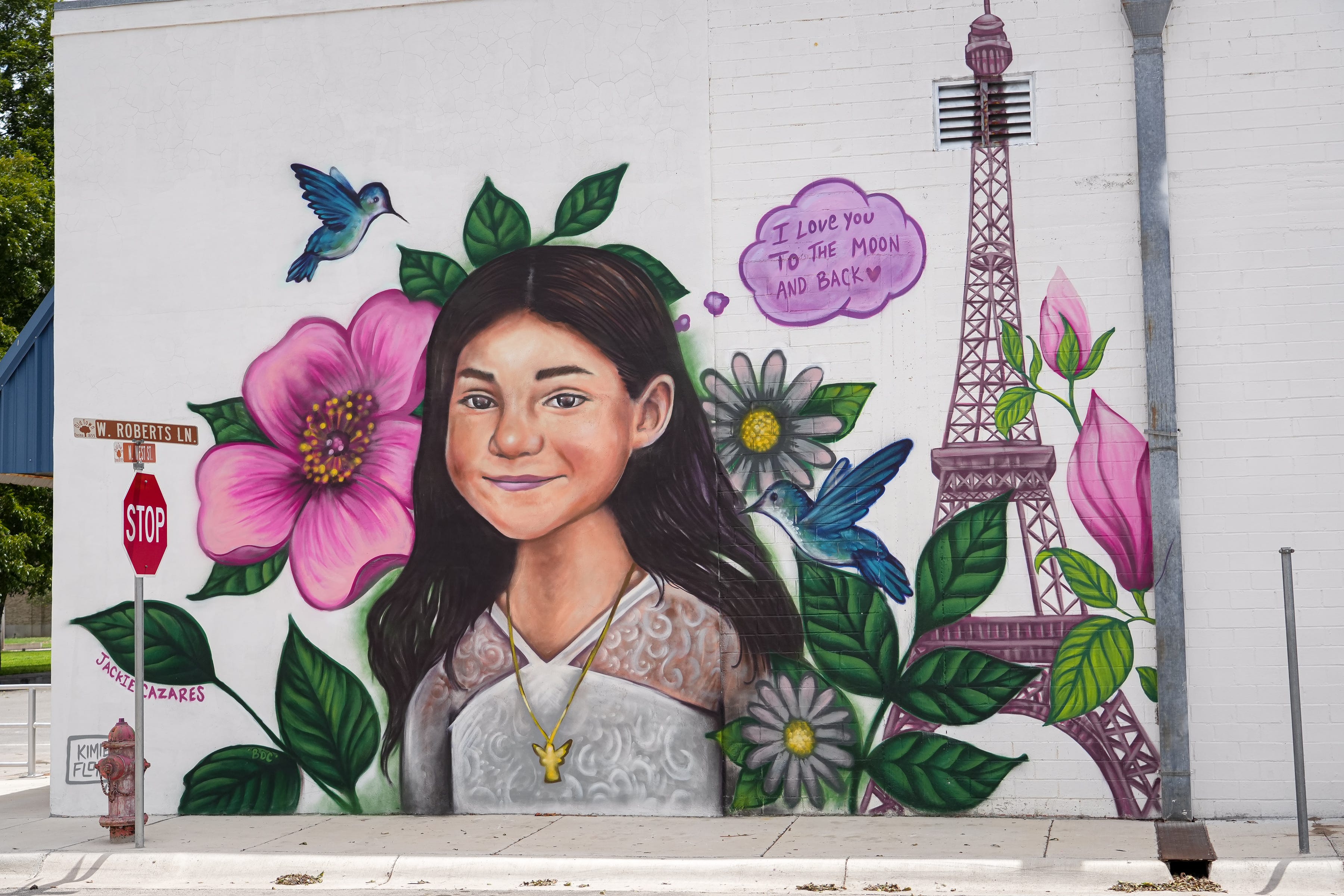 Jackie Cazares and her family always told one another, "I love you to the moon and back." Austin artist Kimmie Flores said she made sure to include that in her mural located on the wall of the Evans Law Office at 127 N. West St. in Uvalde.