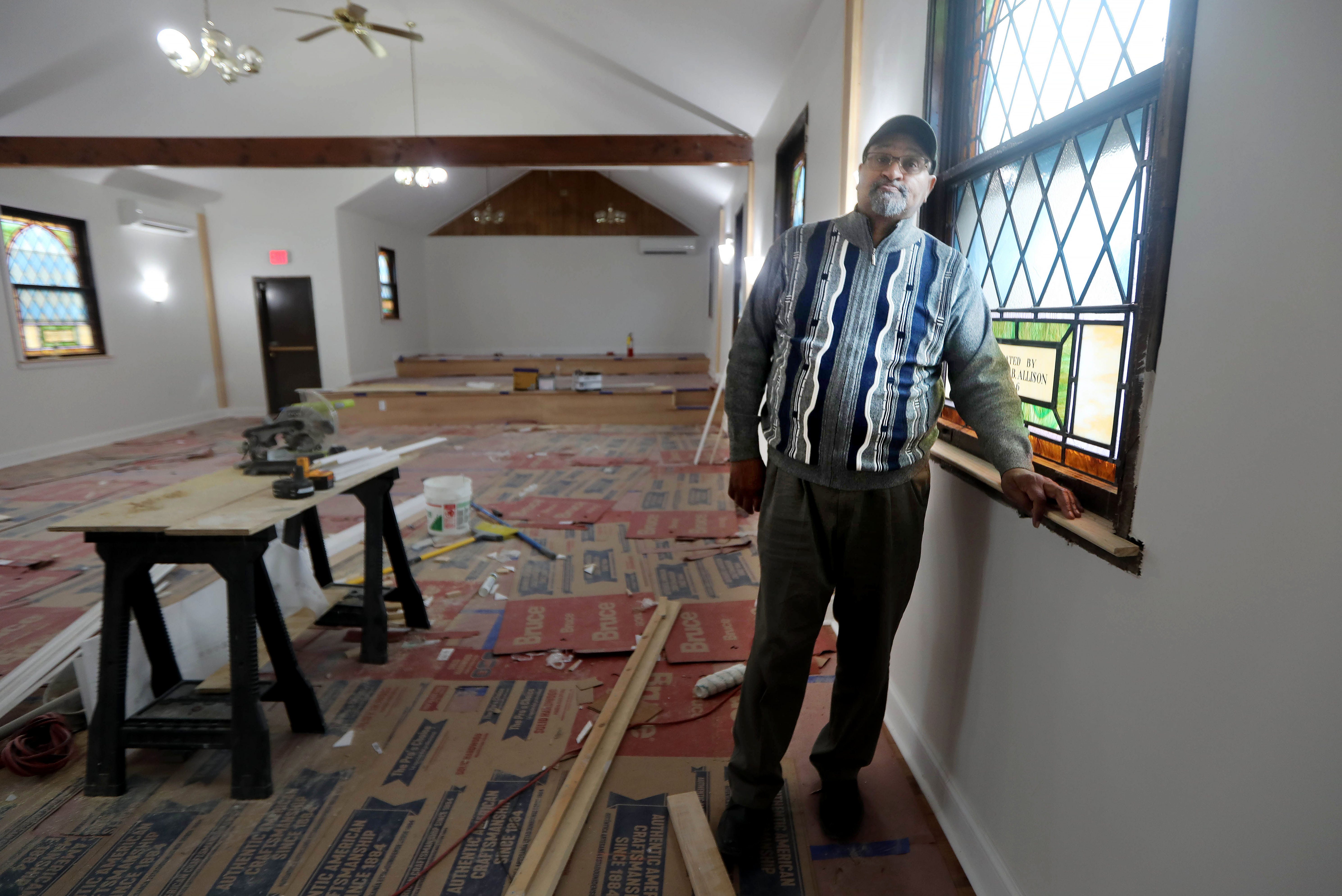 The Rev. James E. Taylor, pastor of the First Baptist Church in Mamaroneck, stands in the church sanctuary March 9, 2022. The church was closed after being severely damaged by several feet of flooding caused by Hurricane Ida in 2021.