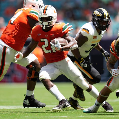 Miami running back Henry Parrish Jr. (21) runs the