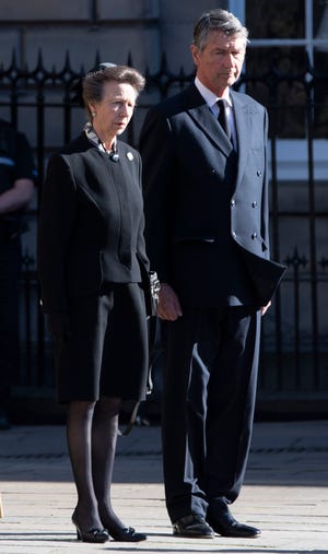 Princess Anne and husband Vice Adm.  Sir Timothy Laurence watches as the coffin of Queen Elizabeth II is taken to a hearse as it departs St Giles' Cathedral, in Edinburgh, Scotland Sept.  13, 2022, to be flown to London and taken to Buckingham Palace.