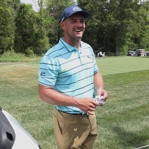 Bryson DeChambeau talks with guests after teeing o