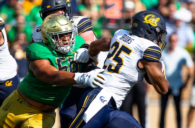 Notre Dame defensive lineman Howard Cross III (56) tries to tackle California running back DeCarlos Brooks (25) during the Notre Dame vs. California NCAA football game Saturday, Sept. 17, 2022 at Notre Dame Stadium in South Bend.